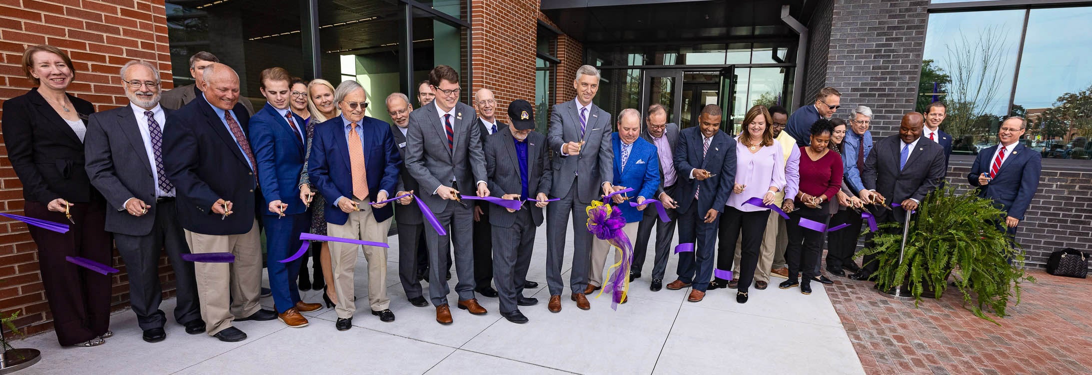 Chancellor Philip Rogers, ECU Board of Trustees members and other dignitaries cut the ribbon to officially open the new Life Sciences and Biotechnology Building.