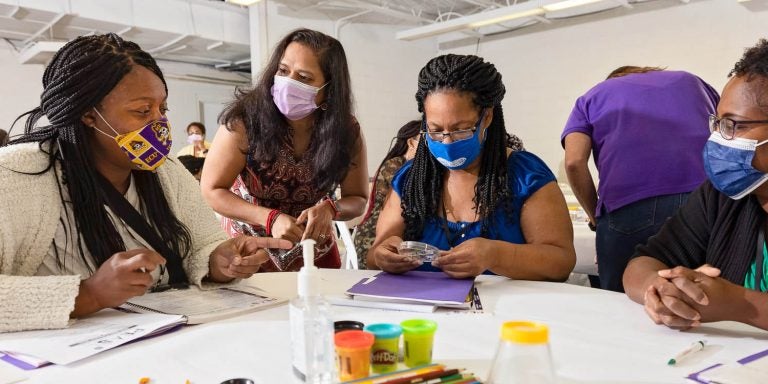 From left, Teronica Felton, ECU faculty member Archana V. Hedge, Phyllis Robbins and Nedra Simmons examine and discuss a pillbug as part of a PEAS teacher workshop in August. (Photos by Cliff Hollis)