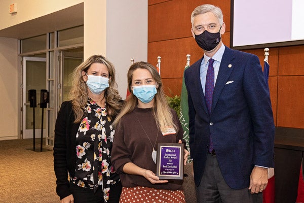 Betul Kucukardali, center, an international doctoral student in marriage and family therapy, was honored for her research work by Dr. Jennifer Hodgson and Chancellor Philip Rogers.