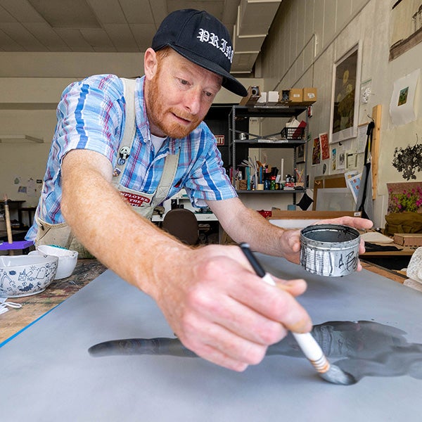 ECU student Adam Berman works on a print in Jenkins Fine Arts Center.