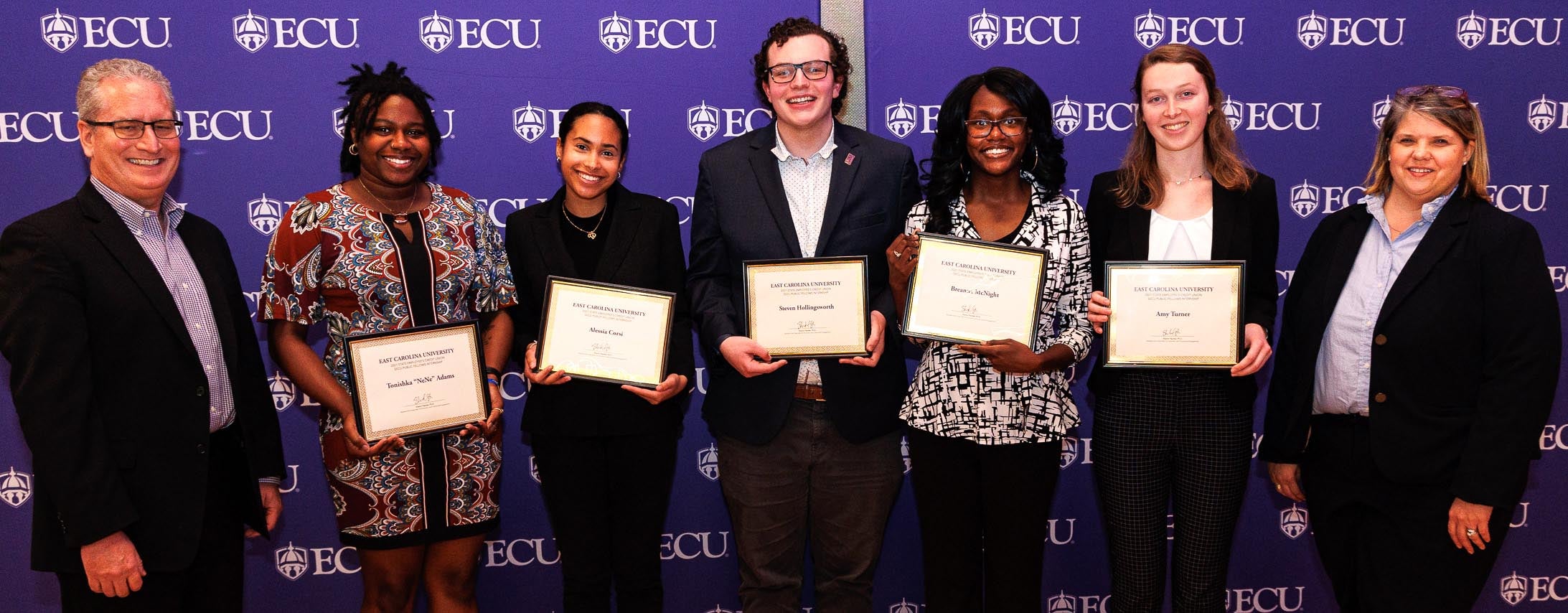 Rich Hutson, left, senior vice president of the State Employees’ Credit Union, and Sharon Paynter, far right, assistant vice chancellor for economic and community engagement at ECU, recognized the SECU Public Service Fellows who were able to attend the ceremony.