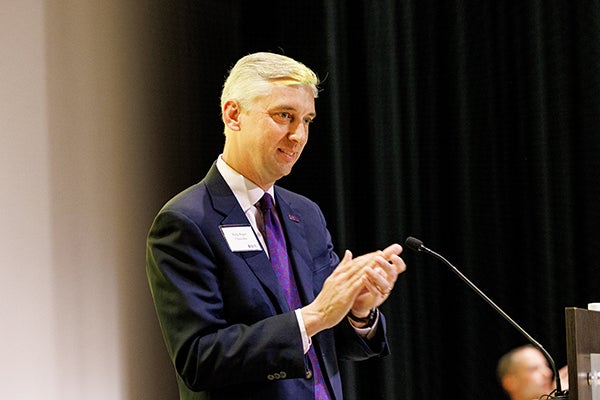 Chancellor Philip Rogers applauds during the Golden LEAF Scholars Luncheon in the Black Box Theater at the Main Campus Student Center. 