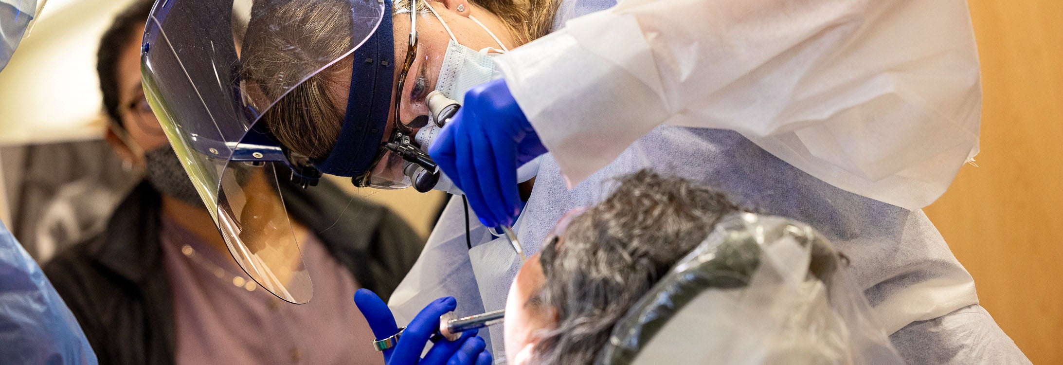 An ECU dental student works on a patient.