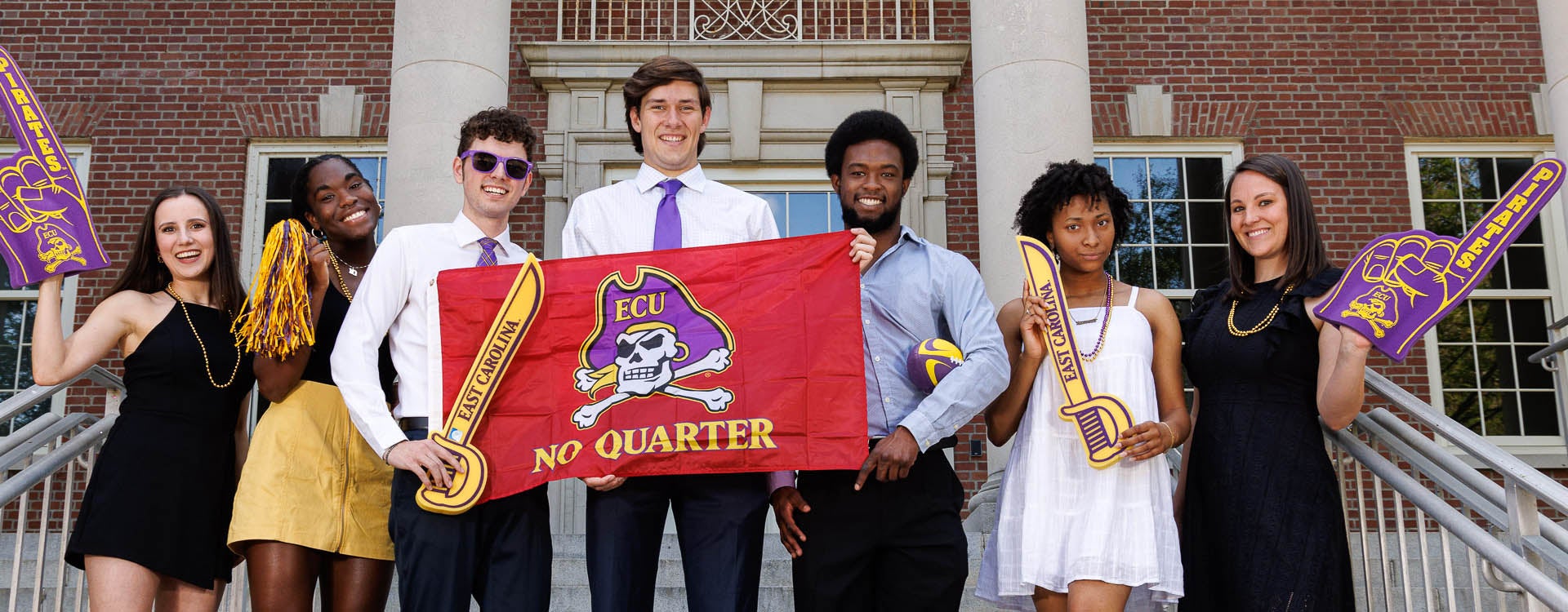 ECU grad profile Ashley Guttenberger holds a Pirate foam finger with her fellow grad profile nominees.
