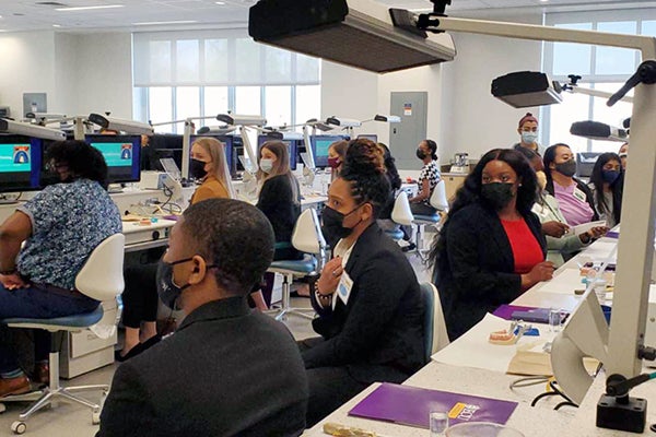 Undergraduate and post-graduate students listen to a presentation on ECU's School of Dental Medicine during the school's fifth annual Impressions Day.