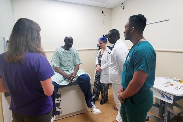 Students from colleges and schools on ECU’s Health Sciences Campus interact with a standardized patient during the Truist Developing Future Interprofessional Healthcare Leaders workshop. 