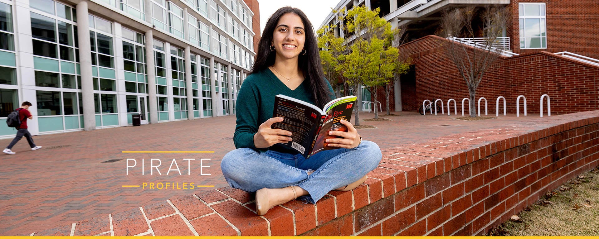 ECU student Ishani Shelat sits near the Sci-Tech Building.