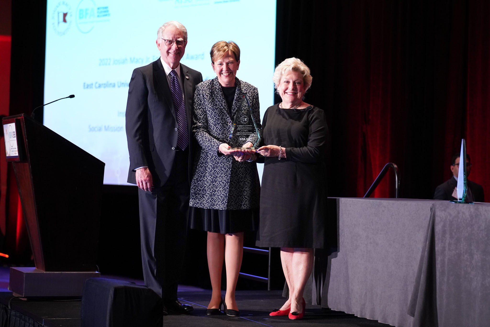 ECU School of Dental Medicine Dean Dr. Greg Chadwick, left, and Dr. Margaret Wilson, vice dean, right, accept the Josiah Macy Jr. Foundation Award for Excellence in Social Mission in Health Professions Education March 28 from Dr. Holly Humphrey, president of the Josiah Macy Jr. Foundation. (Contributed photo)