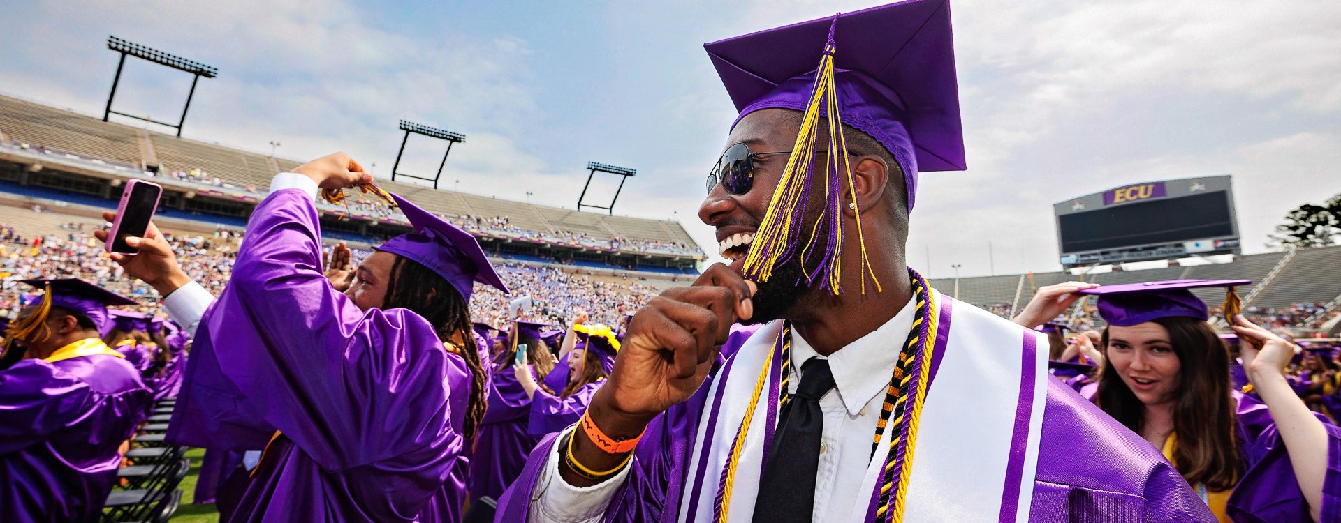 Ravian Jordan, left, and Kayin Fails turn their tassels at commencement. (Photo by Cliff Hollis)