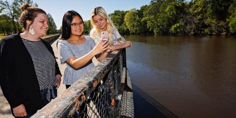 Dr. Emily Yeager spends time her with student researchers Anjalee Hou, center, and Taylor Cash.