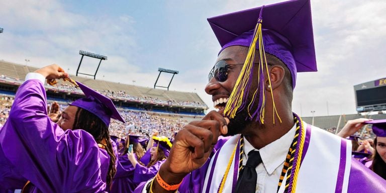 Ravian Jordan, left, and Kayin Fails turn their tassels at commencement.
