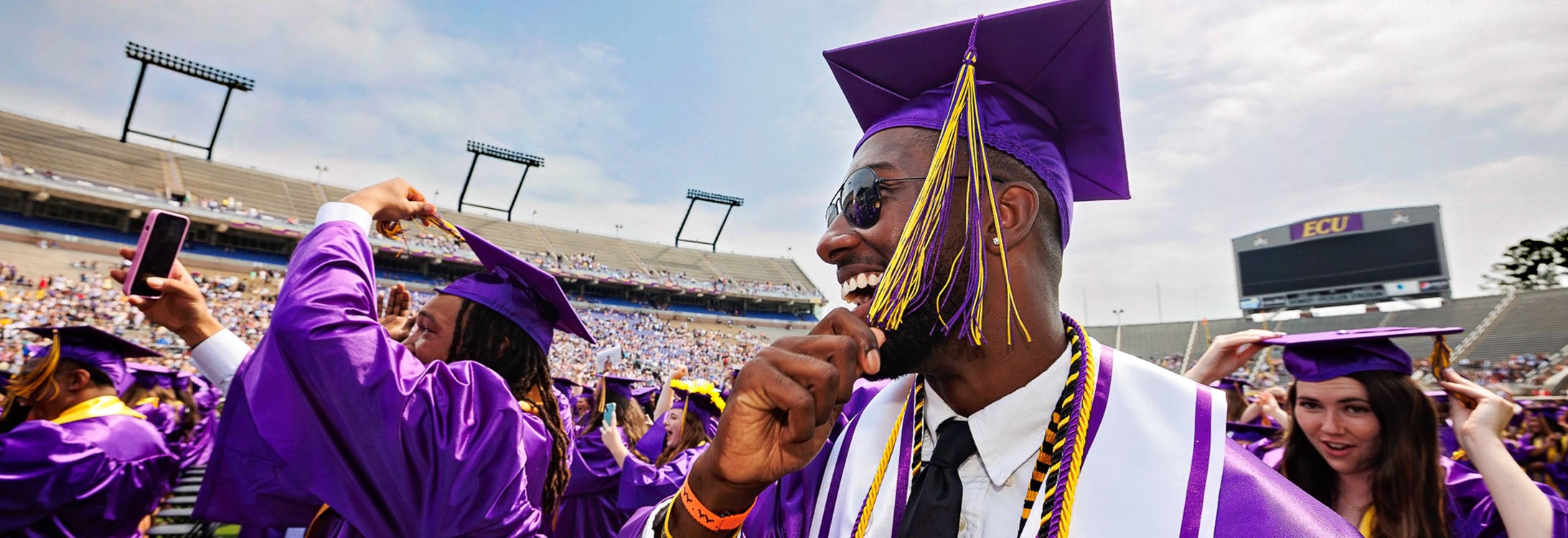 Ravian Jordan, left, and Kayin Fails turn their tassels at commencement.