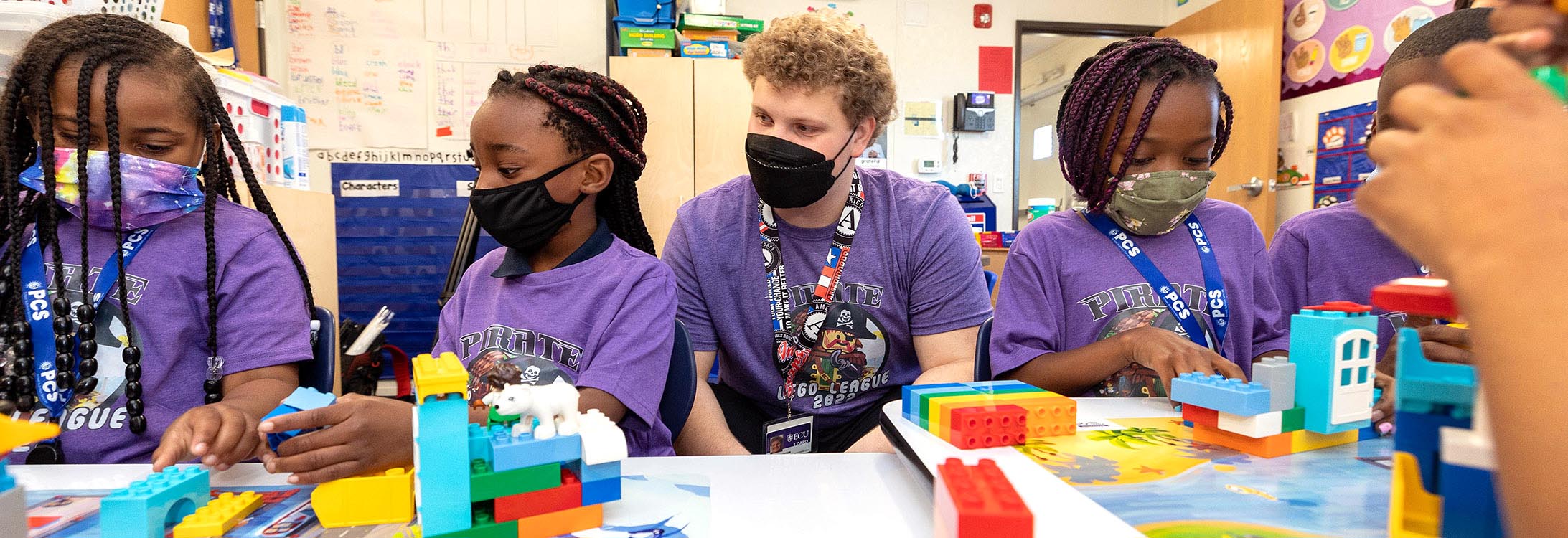 J.H. Rose High School senior Carter Lamson works with students at the ECU Community School on a LEGO League program.