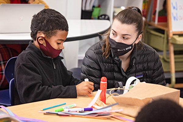 EC Scholar Sophie Villani helps second-grader Ramere Baker create an art project at the ECU Community School in February 2021. Honors College students started partnering with the Community School in the 2020-21 academic year.