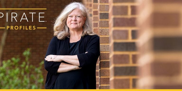 Dr. Courtney Caiola poses in front of a building.