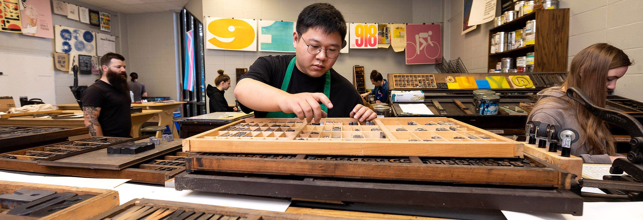 East Carolina University student Frank Liu works on a project in an experimental letterpress print class.