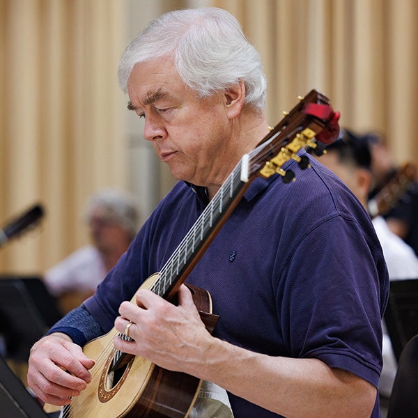 William “Mac” Nelson of Greensboro plays with the guitar ensemble in Fletcher Recital Hall.