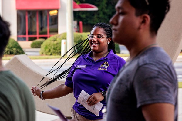 ECU orientation assistant Aniah Atkinson welcomes incoming students and family members at the Main Campus Student Center.