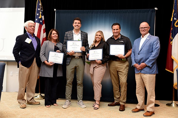 Newly certified North Carolina Certified Economic Developers include Kara Brown, from center left, Nathaniel Dick, David Frescatore and Elizabeth Underwood. The certification program is a partnership between ECU’s Research, Economic Development and Engagement office and the North Carolina Economic Development Association.