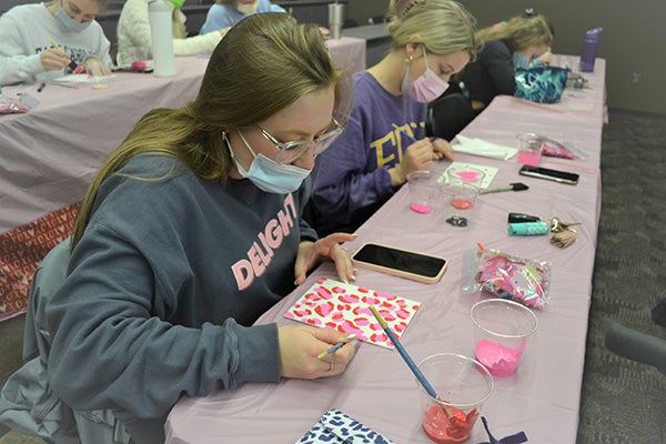 Communication Sciences and Disorders students paint Valentine’s Day gifts for residents of a nursing home near ECU’s campus in Greenville. 