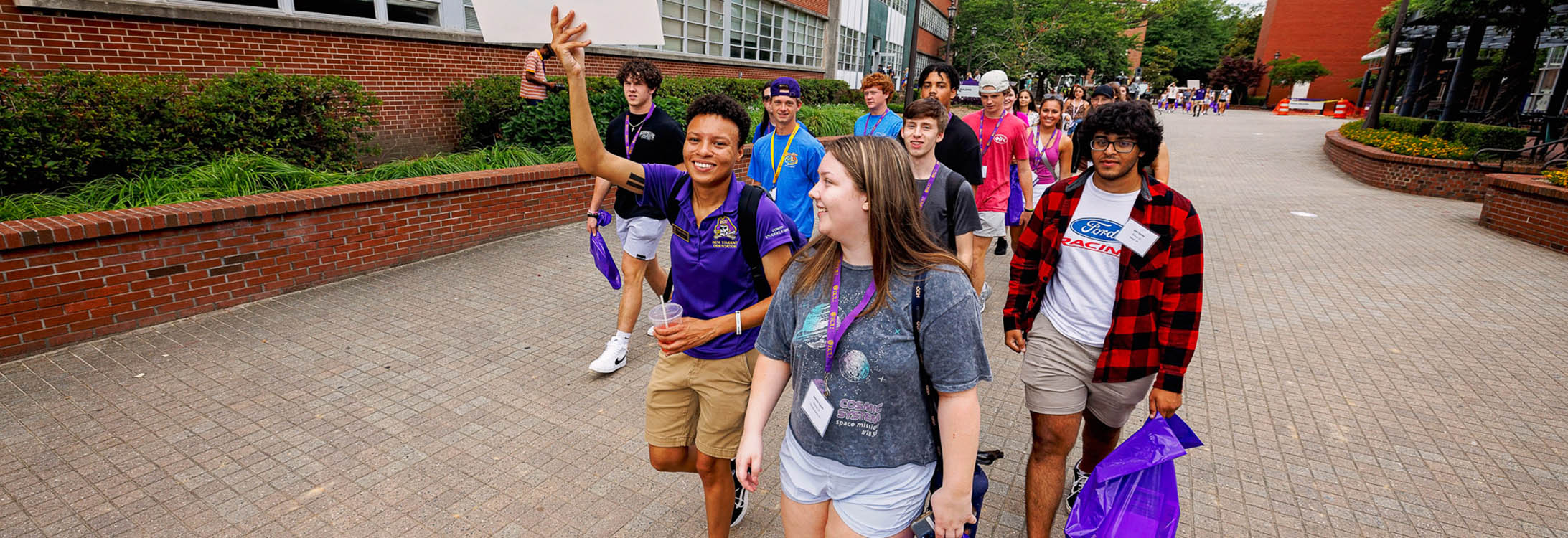 Orientation assistants and alumni lead campus tours for incoming students and their family members.