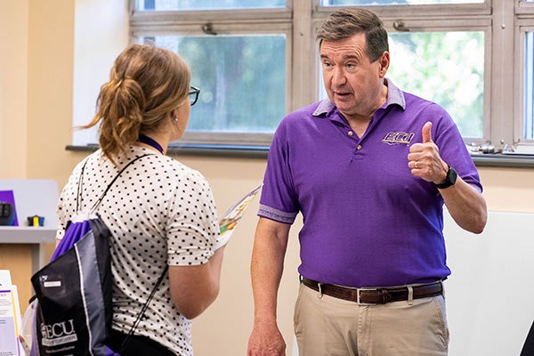 Dr. Ron Preston, an ECU mathematics education faculty member, advises one of the high school students attending the PIRATE Institute. 