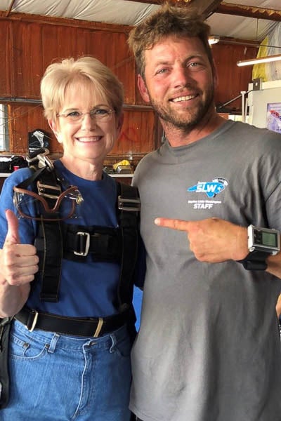 LuAnn Sullivan poses with her skydiving instructor. She celebrated her 60th birthday with a tandem jump. 