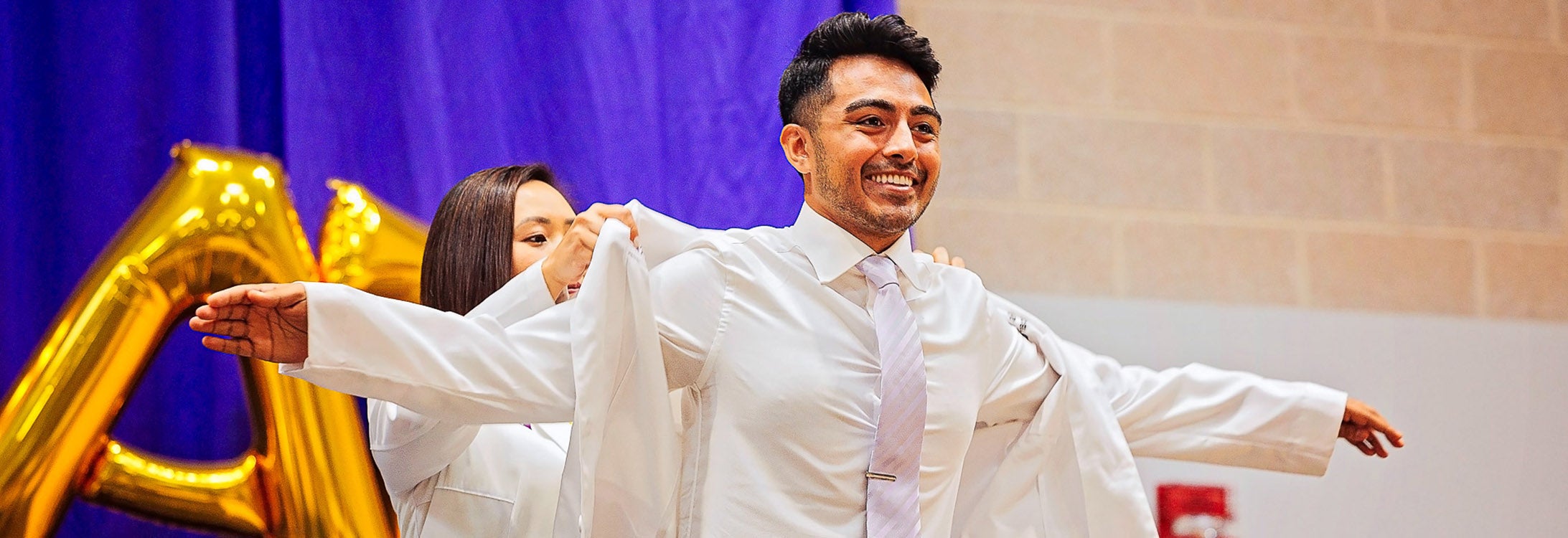 First-year medical student Haris Shehzad receives his white coat during The Brody School of Medicine at East Carolina University’s annual White Coat Ceremony on July 29.