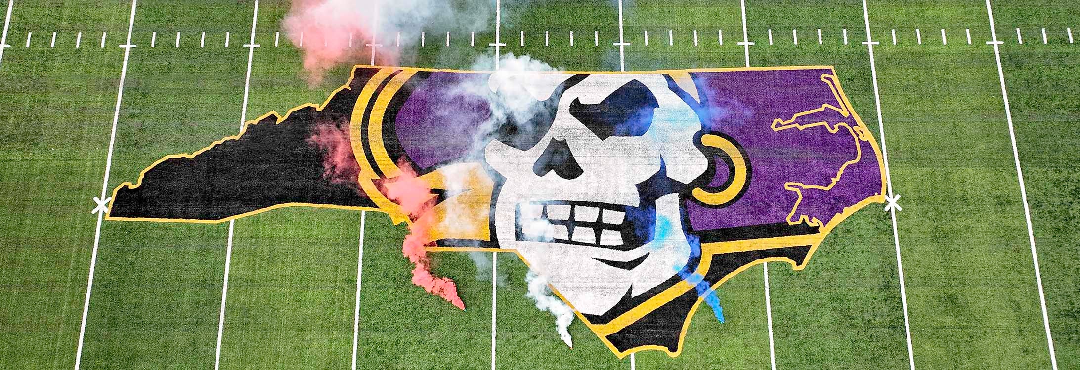 Red, white and blue smoke billow on the ECU football field over the Pirate decal. Supporters of East Carolina University raised a record $69.8 million during the 2021-22 fiscal year.