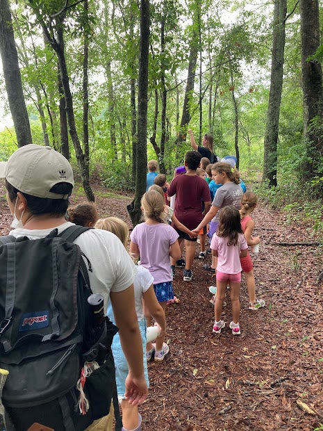 Martinez-Santoyo helps lead a hike for campers at A Time for Science.