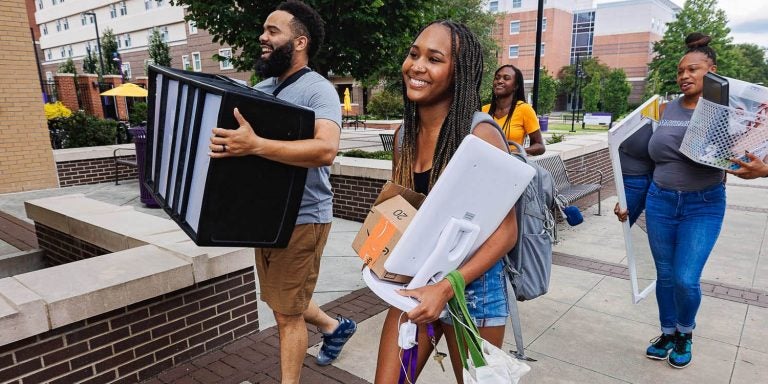 Freshman Faith Spencer gets help from family members as she moves into Ballard Hall. Spencer is majoring in social work and will be part of ECU's track team.