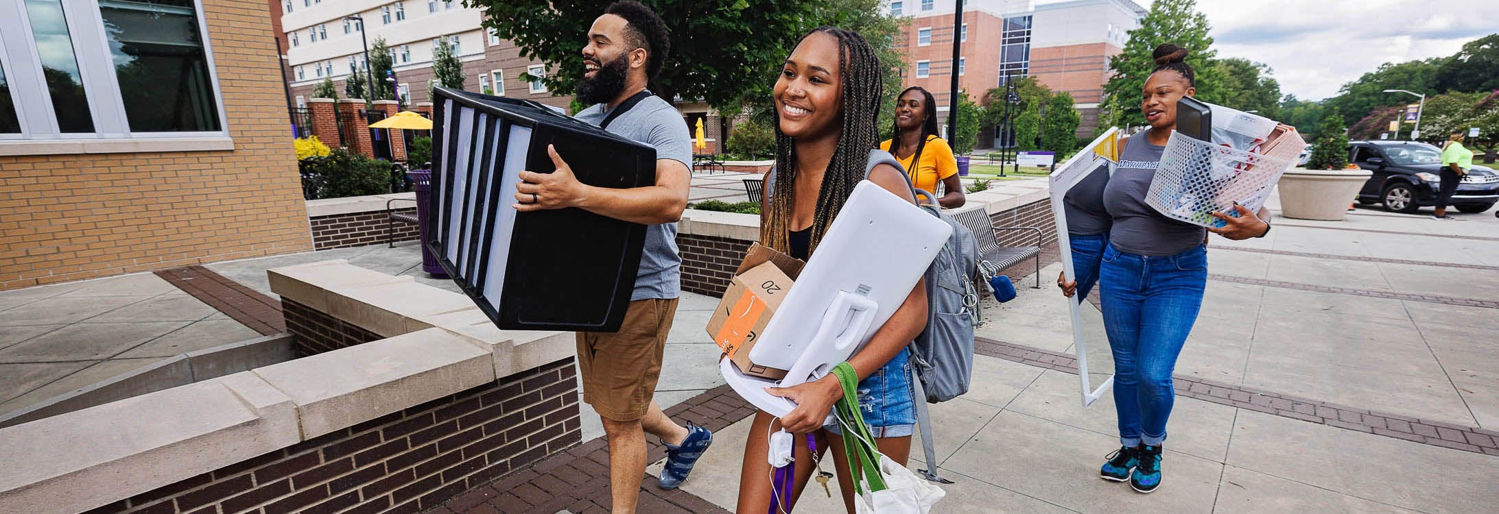 Freshman Faith Spencer gets help from family members as she moves into Ballard Hall. Spencer is majoring in social work and will be part of ECU's track team.