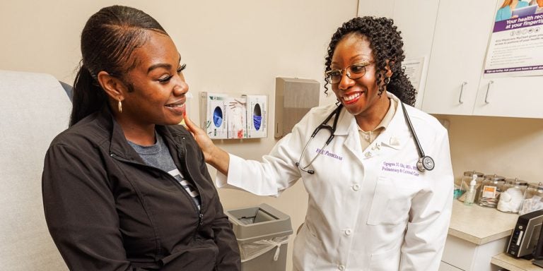 Dr. Ogugua Ndili Obi, assistant professor of pulmonary and critical care, listens to a patient’s lung sounds at Brody School of Medicine’s sarcoidosis clinic.