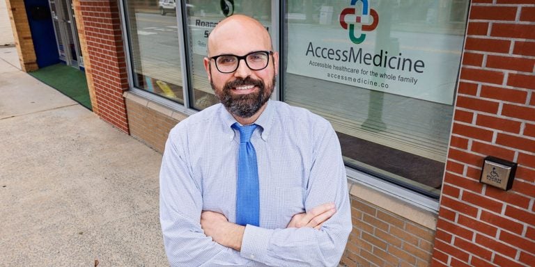 Dr. Steven Manning stands in front of his family medicine clinic, AccessMedicine, in his hometown of Williamston.
