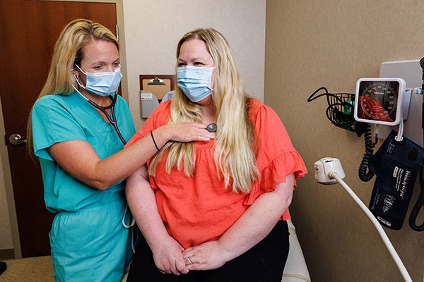 Stegall '12 interacts with a patient at Atrium Health’s Union Family Practice in rural Monroe, North Carolina.
