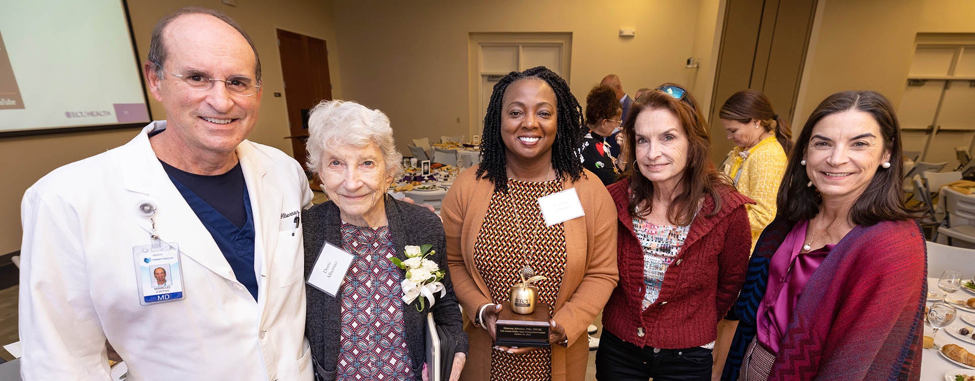 Members of Dr. José G. Albernaz’ family pose with Dr. Sharona Johnson following her remarks.