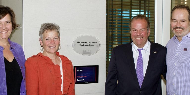 Ashley, Leslie, Justin and Christian Conrad gather at the Main Campus Student Center conference room named in their parents’ memory.