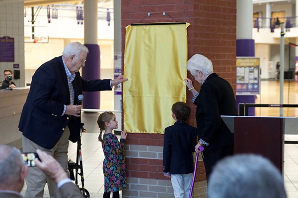 Dick and JoAnn Eakin invited their two young neighbors, Savannah and Bobby Buie, to help unveil a plaque honoring former the chancellor and his wife for their unwavering commitment to student recreation and wellness.