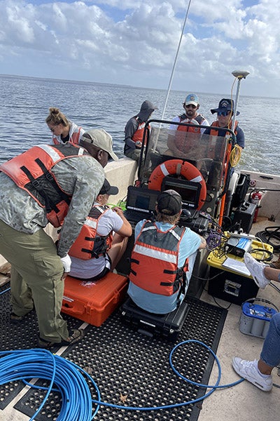 East Carolina University students and staff use a side scan sonar and magnetometer to search the waters of Albemarle Sound.