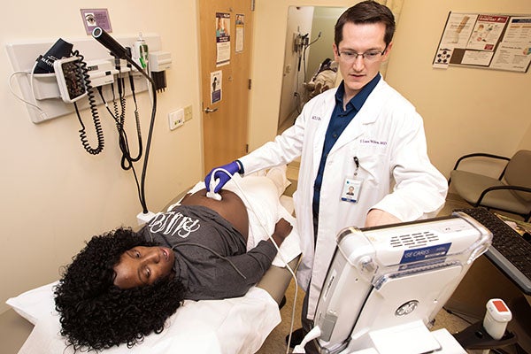 Dr. J. Lane Wilson monitors the health and activity of patient Brandy Wiggins’ baby while performing an ultrasound at the Department of Family Medicine at the Brody School of Medicine. 