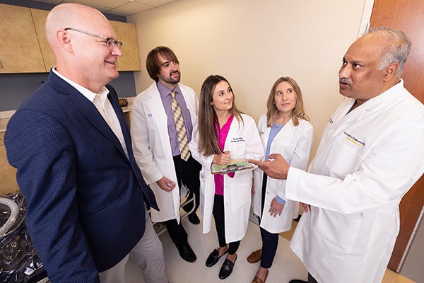 Sam Sears, left, director of ECU’s clinical health psychology program, discusses the field of cardiac psychology with doctoral students Zachary Force, Scarlett Anthony and Elizabeth Jordan, as well as Dr. Raj Nekkanti, right, director of ECU’s cardiac fellowship program.