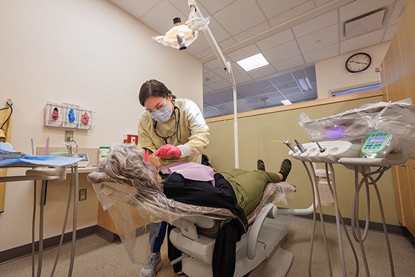 Fourth-year dental student Kari Wordsworth provides care to a patient during her rotation at the School of Dental Medicine’s community service learning center in Spruce Pine.