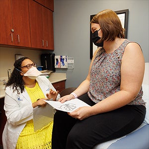 Brody School of Medicine graduate Hannah Woriax, a breast surgical oncologist, talks with a patient in rural Laurinbug, North Carolina.