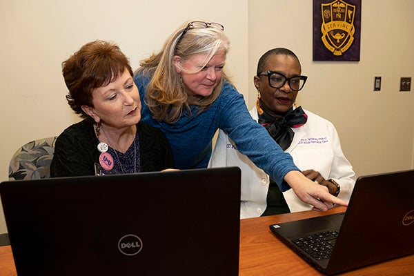 Courtney Caiola speaks with Community/Clinician Advisory Board members Donna Roberson and Grace Wilkins about her HIV research with women in rural areas of North Carolina.