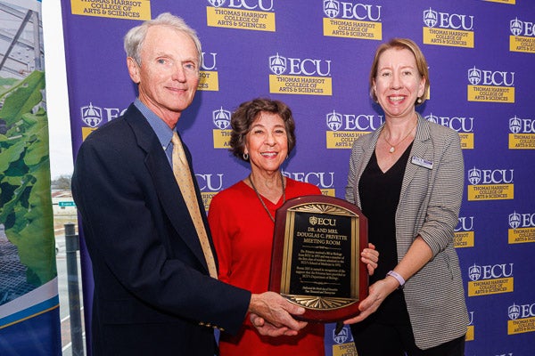 Allison S. Danell presents Doug and Terry Privette a plaque commemorating the naming of the Dr. and Mrs. Douglas C. Privette Meeting Room at East Carolina University's Life Sciences and Biotechnology Building. (Photos by Cliff Hollis)