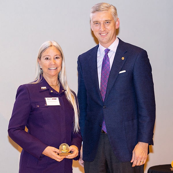 Diana Haytko receives a Leo W. Jenkins Society medallion from Chancellor Philip Rogers.