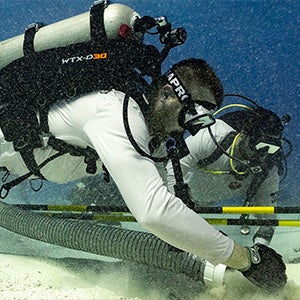 A pair of Task Force Dagger Foundation veterans excavate a unit. East Carolina University researchers and Task Force Dagger continue to search for and recover missing aircraft and WWII personnel off the coast of Saipan. 