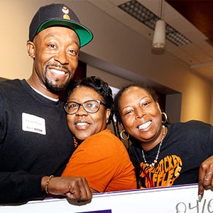 Jamerus Payton, left center, owner of Carolina Chicken and Waffles, celebrates with his family after winning the fifth annual Pirate Entrepreneurship Challenge. 