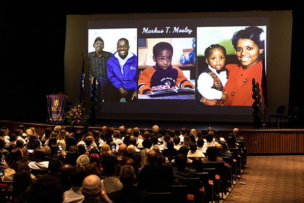 Before each student walked across the stage and donned his or her white coat, a special personalized slide was shared with the audience. Student Markus Mosley prepares to receive his white coat.