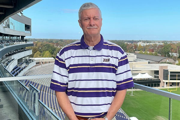 ECU alum Duane Grooms poses at Dowdy-Ficklen Stadium